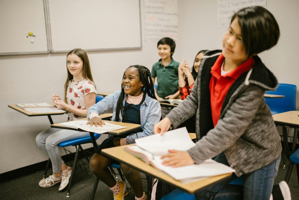 Photo of five children inside a classroom.