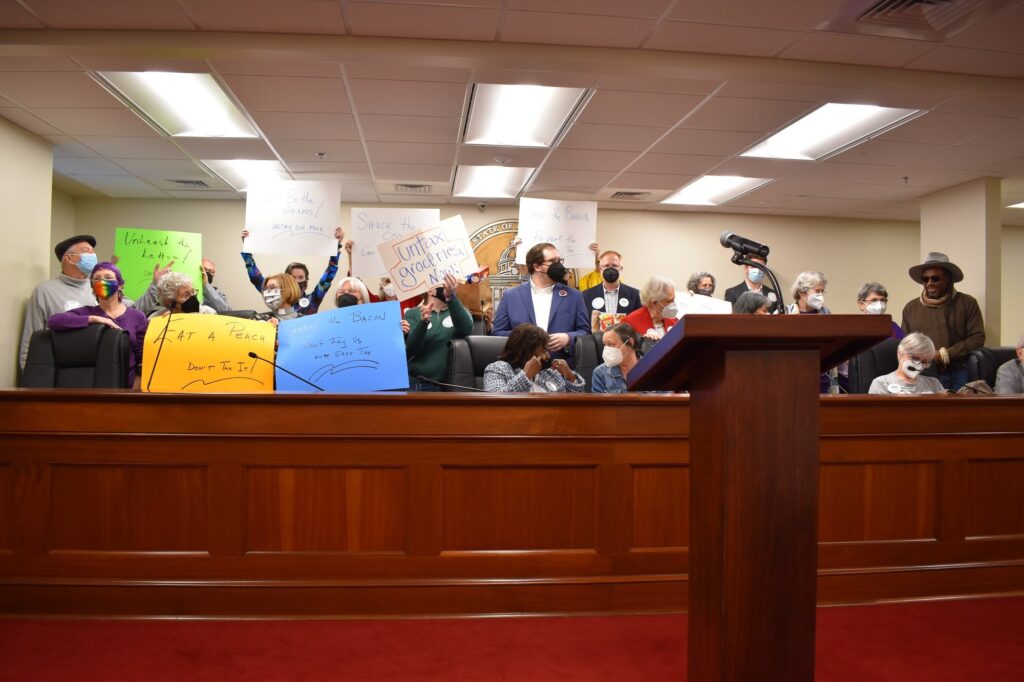 Photo of Arise members rallying against the state grocery tax inside the State House